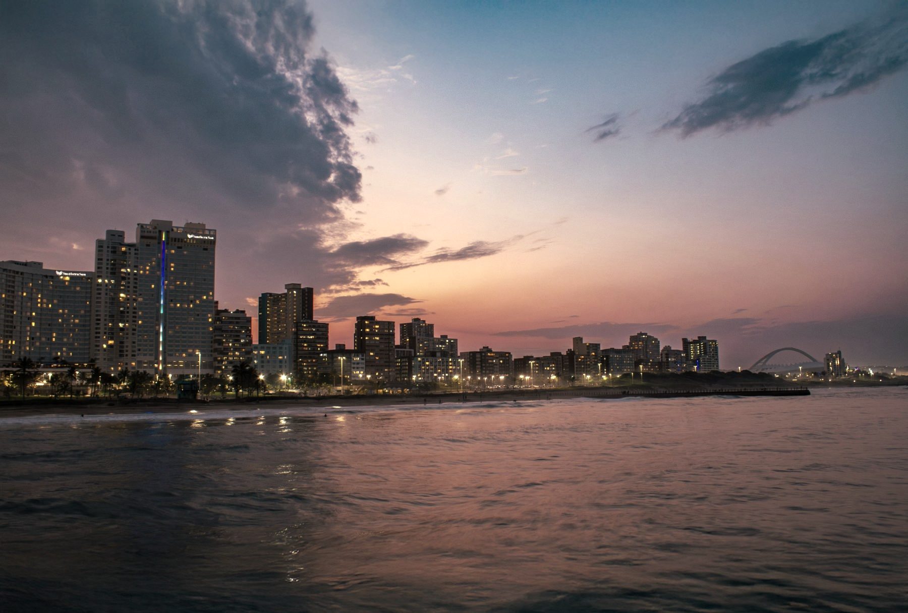 Durban beachfront skyline at sunset, Moses Mabhida Stadium in the distance